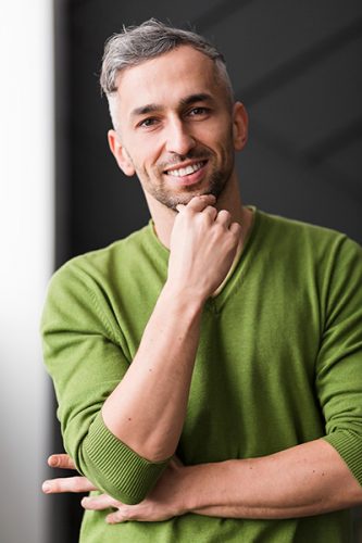 man-green-shirt-smiling-confident